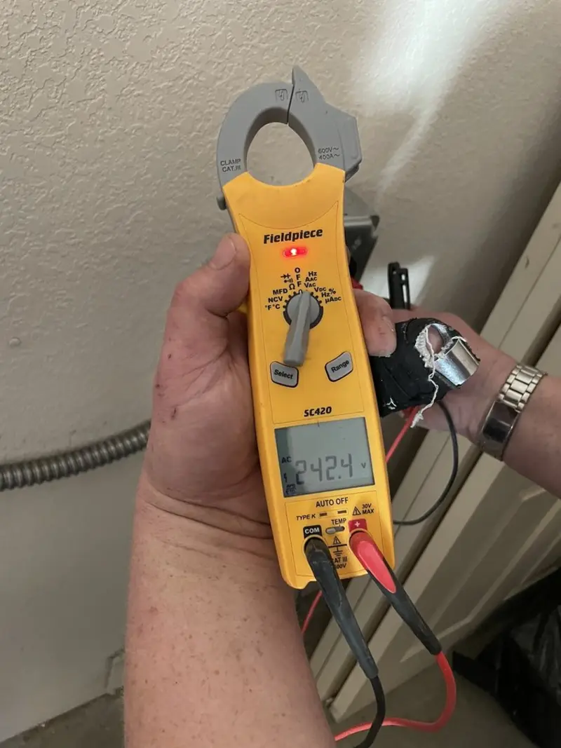Voltage testing with clamp meter during Outlet Installation in Eunice